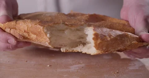 Close up of baker hands breaking homemade bread Stock Footage 156335258