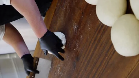 Close-up of a baker hands kneading and shaping bread loaves Video stock 313534572