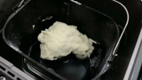 Close-up of a baker kneading dough with Bread Maker machine Video stock 228686243