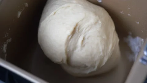Close-up of a baker kneading dough with machine Stock-Footage 132678982