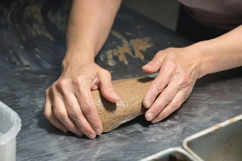 Close-up baker making bread, female hands, kneading dough, cooking Stock Photos
