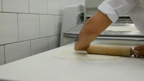 Close-up of baker pours flour in kitchen. Dust the pizza base with flour for the Stock Footage 167021755
