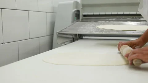 Close-up of baker pours flour in kitchen. Dust the pizza base with flour for the 스톡 동영상 168194061