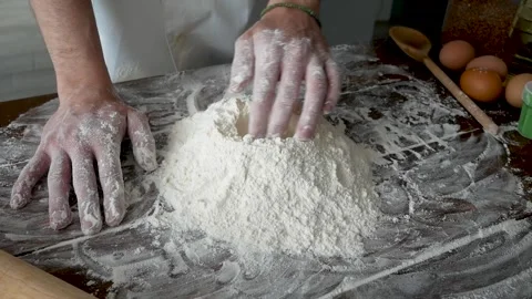Close-up of baker pours flour in kitchen. Action. Baker sprinkles pinch of flour Stock Footage 169864865