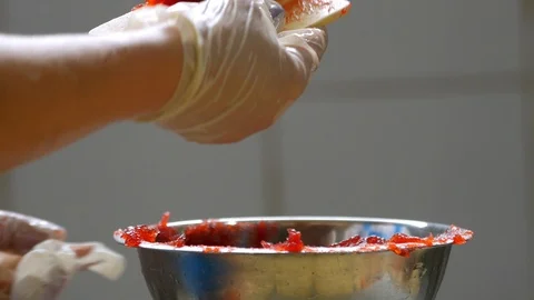 Close up of a bakers hand with gloves on using a scraper to scoop up Stock Footage 104793968