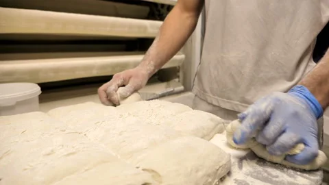 Close up of a baker's hands preparing dough for bread Stock Footage 147065554