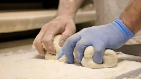 Close up of a baker's hands preparing dough for bread Stock Footage 147065567