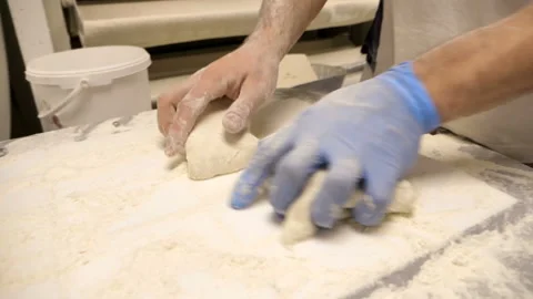 Close up of a baker's hands preparing dough for bread Stock Footage 147065580