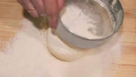 Close-up of a bakery chef sifting flour through a sieve, starting to cook pizza Stock Footage 170754797