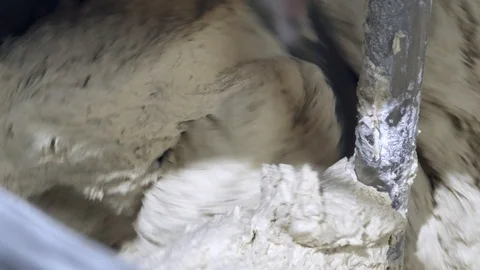 Close up of a bakery machine mixing and kneading dough in a processor in a 스톡 동영상 104793808