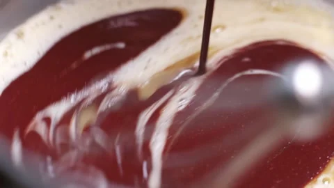Close-up of baking chocolate, stirring, mixing melted chocolate with eggs Stock Footage 237165304