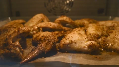 Close-up of baking hot grill chicken legs in the oven. Roasted chicken meat Stock Footage 197441297