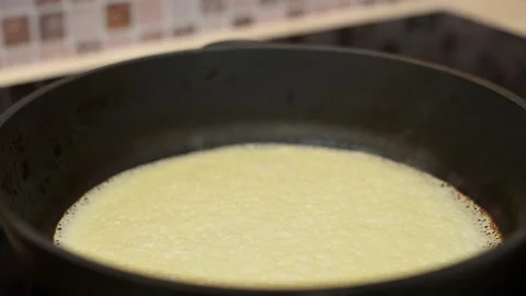 Close-up of baking a pancake in a frying pan. Stock Footage 194566027