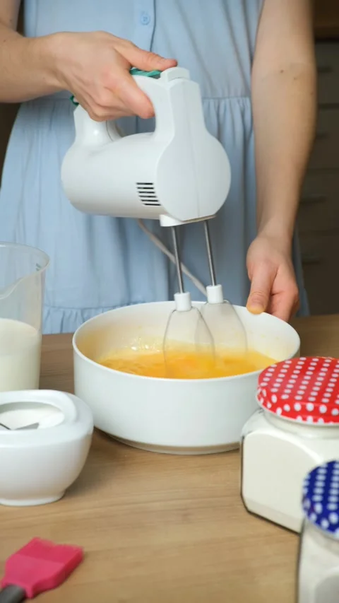 Close-up of the Baking Process. Preparing Dough with a Mixer on a Kitchen Stock Footage 323867050