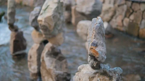 Close-up balancing stone on another stone in bed of mountain river Stock Footage 171341707