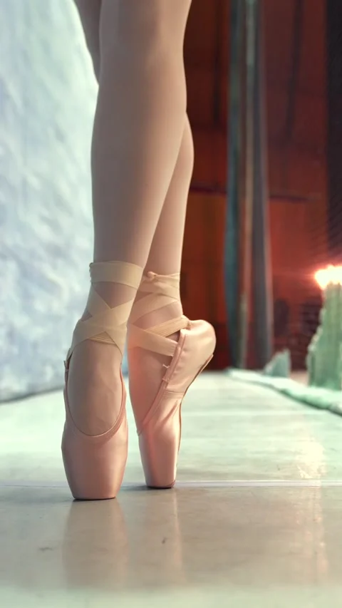 Close up of ballerina standing en pointe backstage in soft stage lighting Stock Footage 314800297