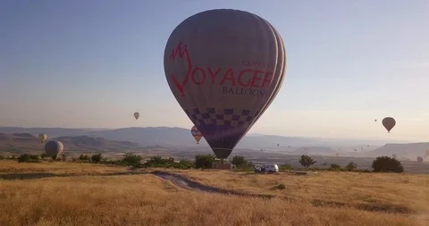 Close-up of a balloon landing on the ground. Panoramic view. Car drives off. Stock Footage 104860800