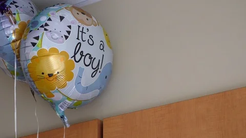 Close up of a balloon stating "Its a boy!" in a room Stock-Footage 87288995
