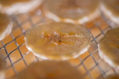 Close up Banana chips drying inside a food dehydrator machine Stock Photos
