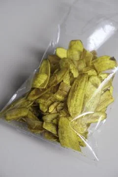 Close-up of banana chips in plastic packaging. Stock Photos
