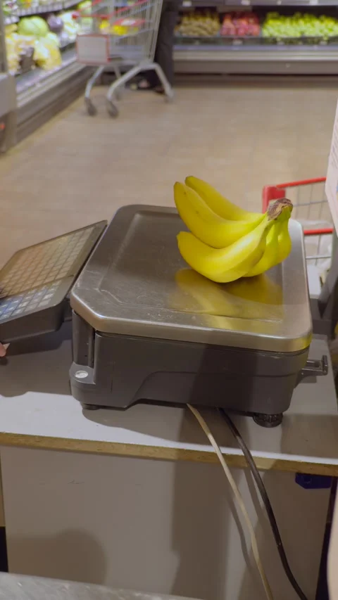 Close-up of bananas being weighed on electronic scale in modern grocery store Stock Footage 318301196