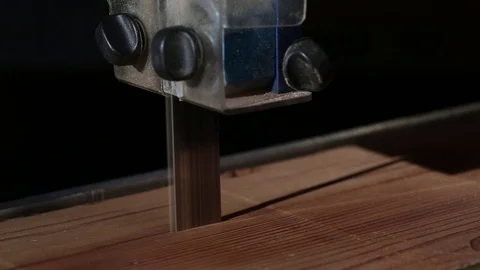 Close up of band saw cutting through wood  库存影片 73756269