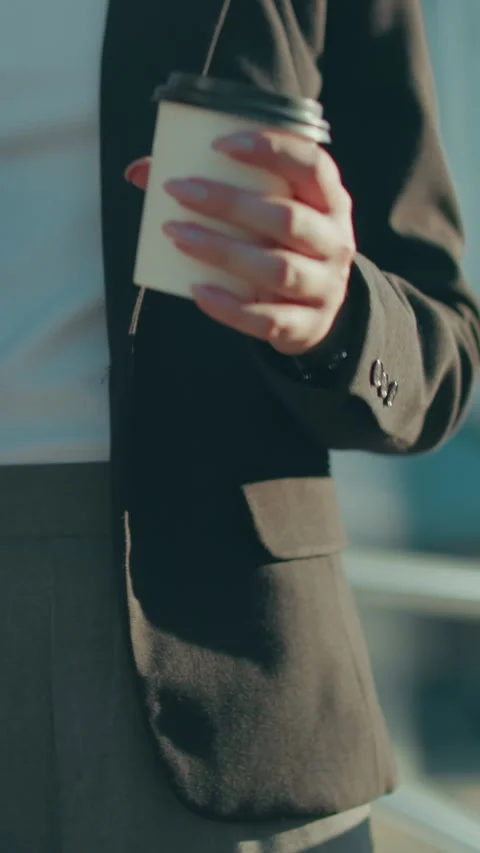 Close Up of Banker Holding Folder and Coffee While Walking in Bright Urban Stock Footage 319745656