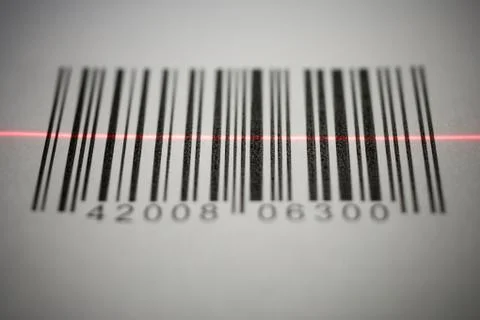 Close-up of a bar code being scanned with a laser light 写真素材
