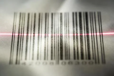 Close-up of a bar code being scanned with a laser light 库存照片