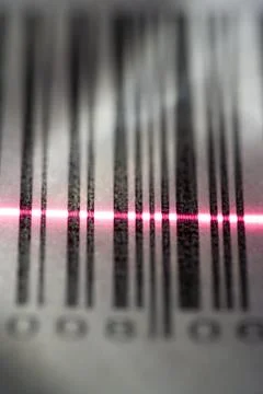 Close-up of a bar code being scanned with a laser light 写真素材