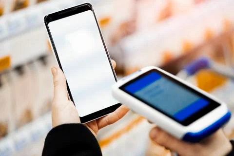 Close up of bar code scanner scanning mobile phone blank screen. Stock Photos