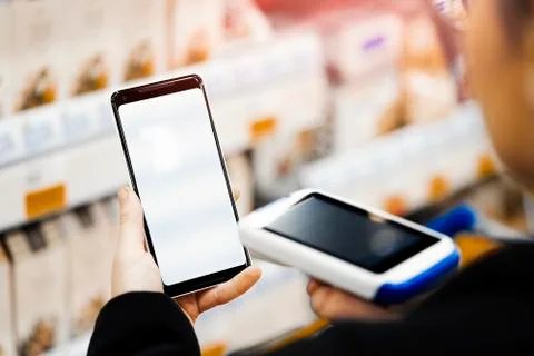 Close up of bar code scanner scanning mobile phone blank screen. 写真素材