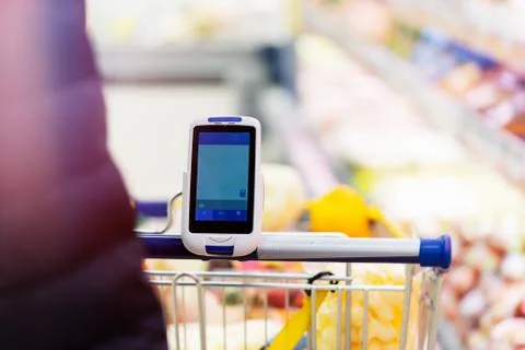Close up of bar code scanner on shopping cart in store. modern gadgets 写真素材