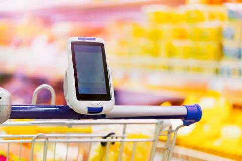 Close up of bar code scanner on shopping cart in store. modern gadgets Stock Photos