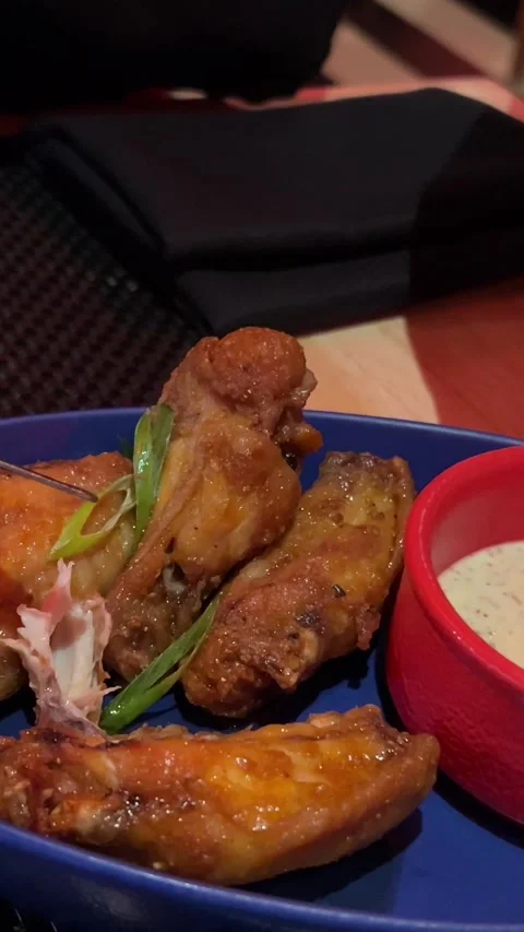 Close-up of barbecue chicken wings served with celery sticks cup of ranch dip on Stock Footage 302069629