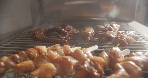 Close-up on barbecue grills grilled beef ribs and chicken skewers Stock Footage 123767889