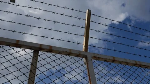 Close-Up Barbed Wire Fence with Rusty Wooden Post Stock Footage 344919684