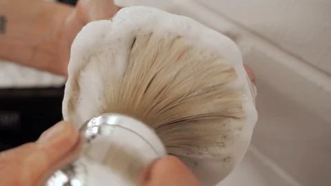 Close-up of a barber makes shaving foam with a shaving brush close up Stock Footage 119135343