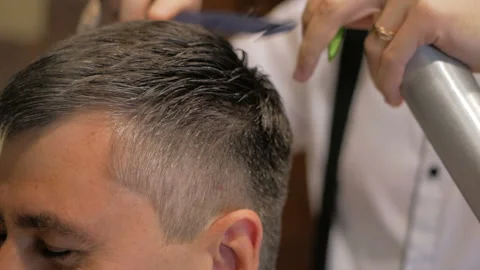 Close-up of barber splashes water on client. Slow motion Stock-Footage 93336014