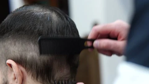 Close up barber styling hair client in the barbershop. Stock Footage 169358844