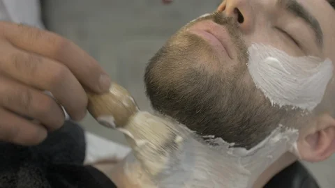 Close-up of a barber's hand wears a mixture for shaving around the neck Stock Footage 112340873