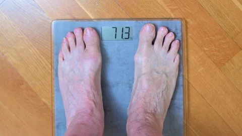 Close Up Of Bare Feet On Digital Scale Showing Body Weight In Kilograms At Home Stock Footage 327957251