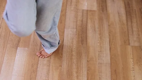 Close-up of bare feet performing rhythmic dance steps on wooden texture 動画素材 332713364