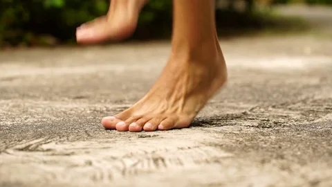 Close-up of bare feet of a young man jumping with skipping rope. Dolly shot Stock Footage