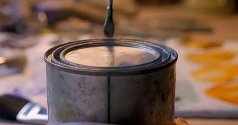 Close up of a bare hand opening a small can with a paint can opener Video stock 120638590
