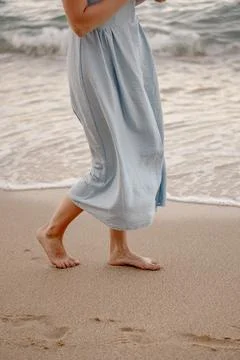 A close-up of barefoot steps along the sandy shoreline Gentle Steps by the .. Stock Photos
