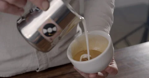 Close up barista hand making coffee art in bar. How to making coffee art with Stock Footage 131129185