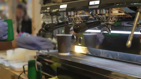 Close-up of barista hands, preparing a hot milk foam, pourin milk in paper cup Stock Footage 84585060