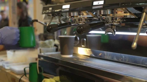 Close-up of barista hands, preparing a hot milk foam, pourin milk in paper cup Stock Footage 85039949