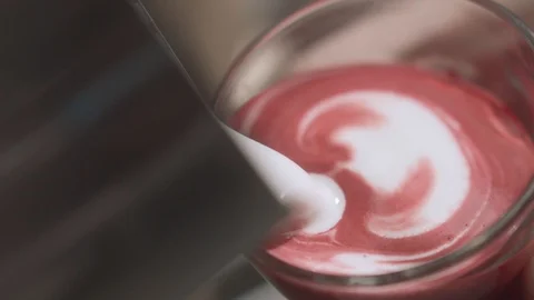 Close-up of barista making pattern of pouring milk in pink matcha Stock Footage 114804615